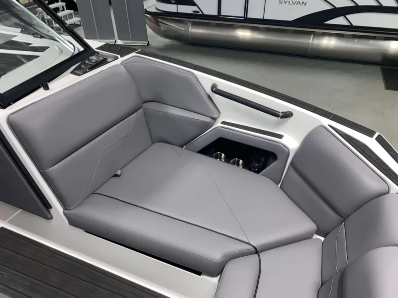 Slide: The Image of 2025 Moomba Max boat interior with gray seating and storage compartment. - 17