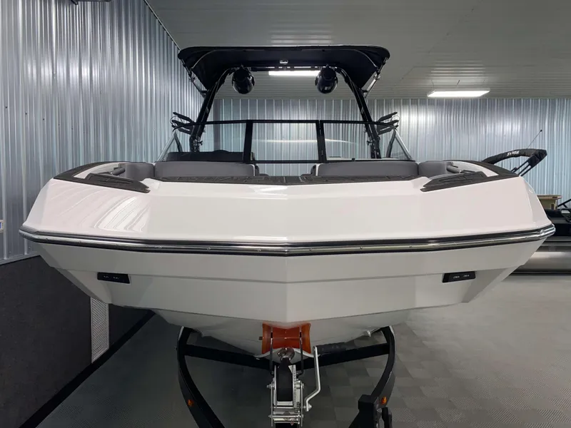 Slide: The Image of 2025 Moomba Max boat in showroom, front view, sleek design, modern features. - 20