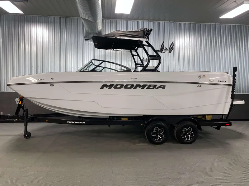 Slide: The Image of 2025 Moomba Max boat in showroom, side view, on trailer. - 21
