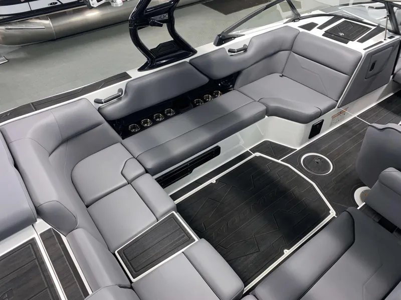 Slide: The Image of 2025 Moomba Max boat interior with sleek gray seating and modern design. - 6