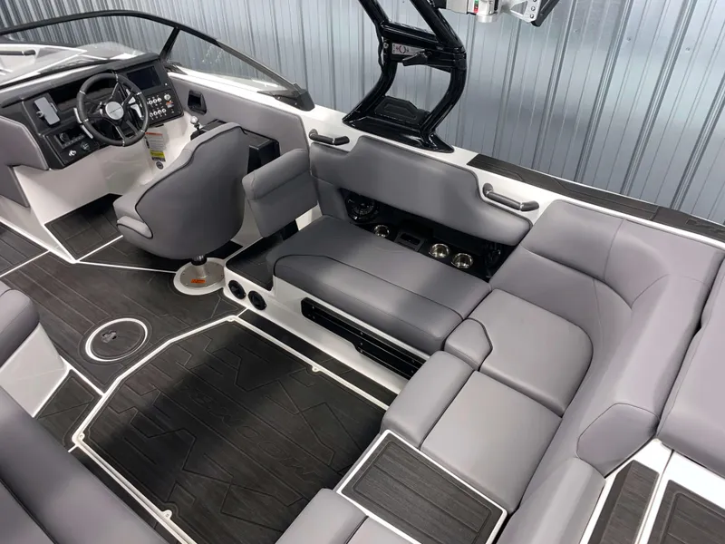 Slide: The Image of 2025 Moomba Max boat interior with sleek gray seating and modern dashboard design. - 7