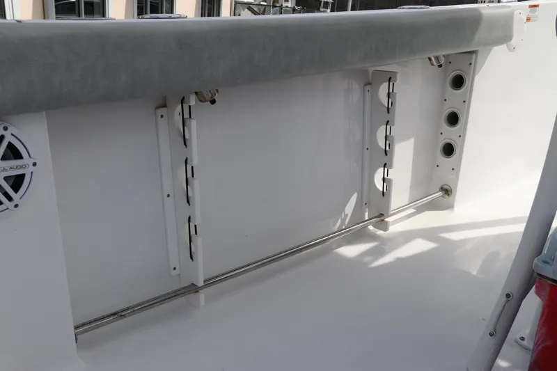 Slide: The Image of 2019 Sportsman Heritage 231 Center Console interior detail with rod holders and speaker. - 11