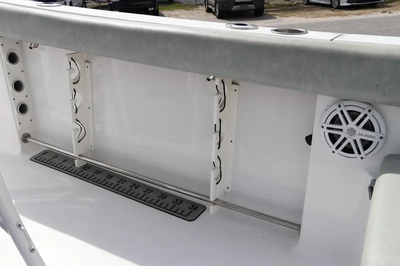 Slide: The Image of 2019 Sportsman Heritage 231 Center Console boat interior with rod holders and speaker. - 12
