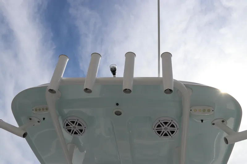 Slide: The Image of 2019 Sportsman Heritage 231 Center Console boat, viewed from below against a cloudy sky. - 15