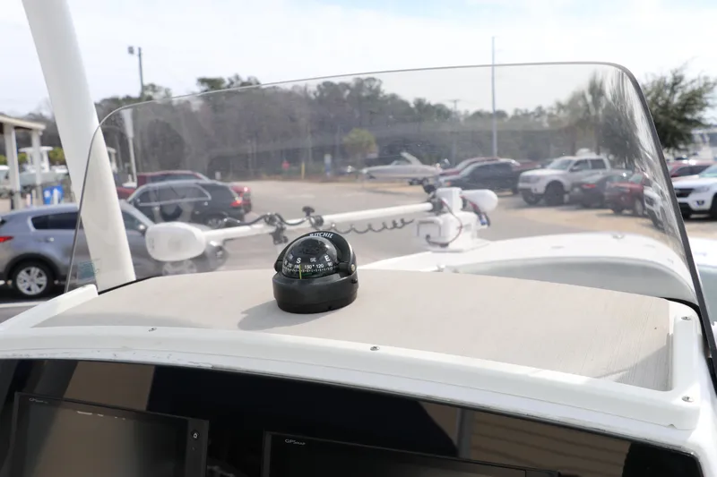 Slide: The Image of 2019 Sportsman Heritage 231 Center Console boat dashboard with compass and windshield. - 24