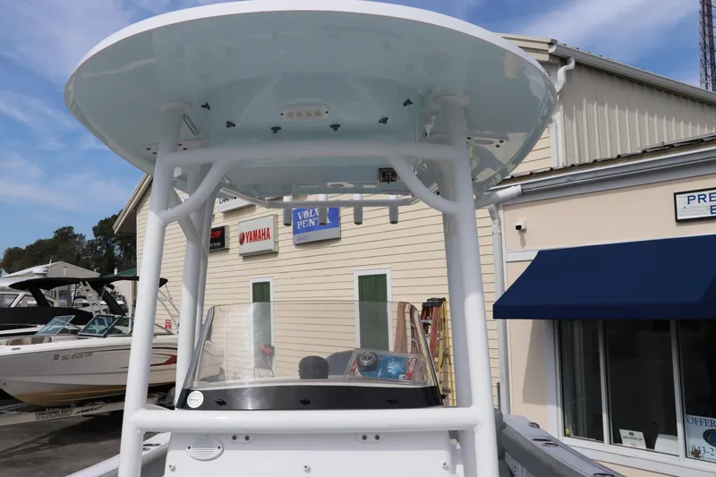 Slide: The Image of 2019 Sportsman Heritage 231 Center Console boat with T-top, docked near a building. - 28