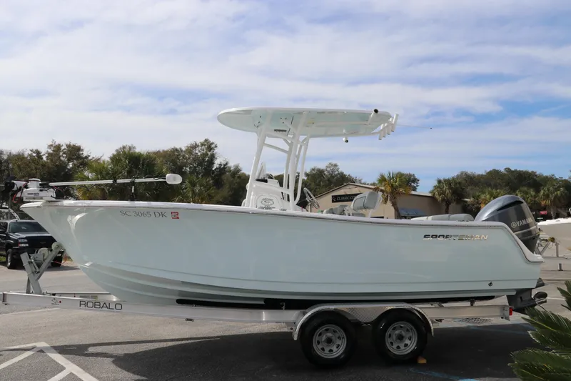 Slide: The Image of 2019 Sportsman Heritage 231 Center Console boat on trailer, parked outdoors. - 3