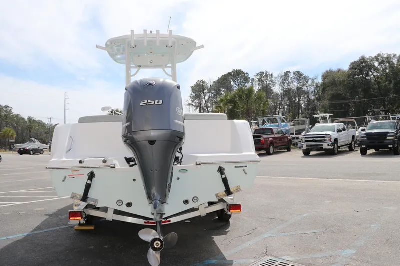 Slide: The Image of 2019 Sportsman Heritage 231 Center Console boat with 250 HP engine in a parking lot. - 5