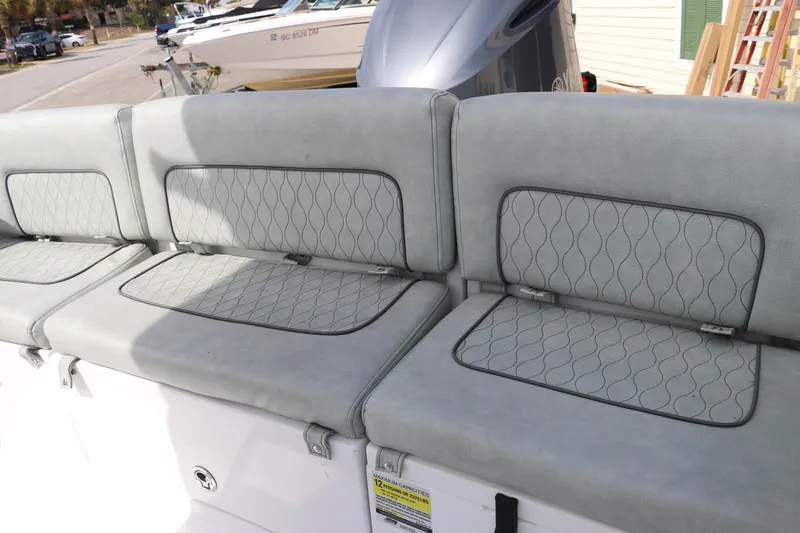 Slide: The Image of 2019 Sportsman Heritage 231 Center Console boat seating with gray upholstery and quilted design. - 9