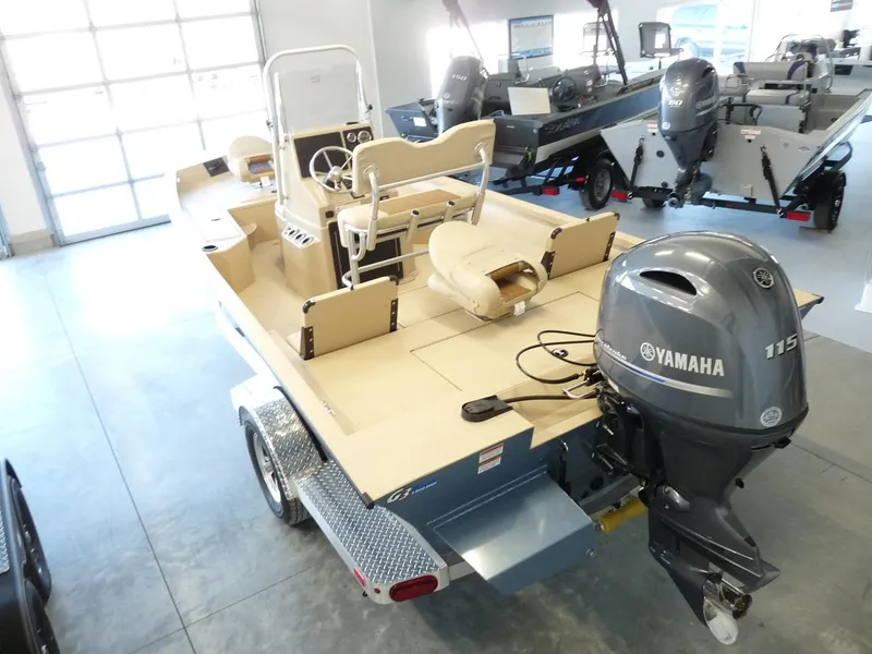Slide: The Image of 2025 G3 Bay 19 GX boat with Yamaha 115 engine in showroom. - 2