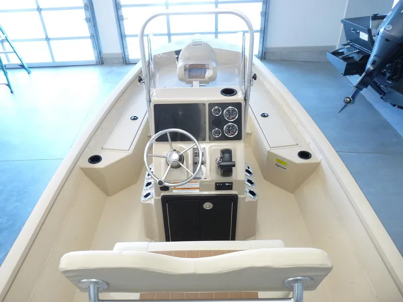 Slide: The Image of 2025 G3 Bay 19 GX boat interior with steering console and seating. - 3