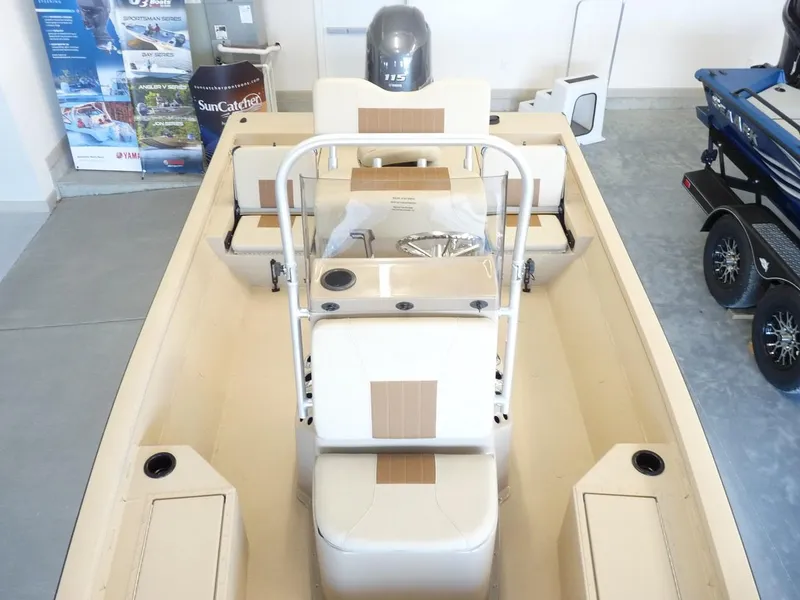 Slide: The Image of 2025 G3 Bay 19 GX boat interior with console and seating, displayed in showroom. - 4
