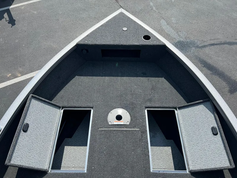 Slide: The Image of 2024 Crestliner 1650 Hawk WT boat interior with open storage compartments. - 12