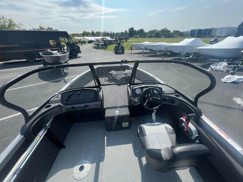 Slide: The Image of 2024 Crestliner 1650 Hawk WT boat interior with steering wheel and seating. - 13