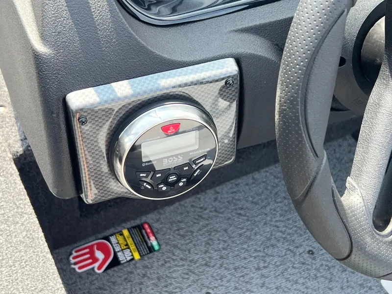 Slide: The Image of 2024 Crestliner 1650 Hawk WT dashboard with stereo system and steering wheel detail. - 14