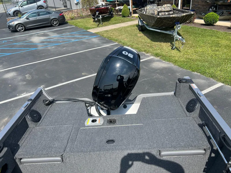 Slide: The Image of 2024 Crestliner 1650 Hawk WT boat with 90 HP outboard motor in parking lot. - 4