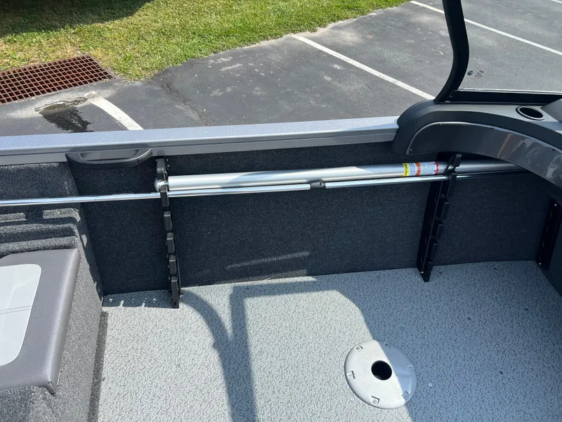 Slide: The Image of 2024 Crestliner 1650 Hawk WT interior with rod holder and seating area. - 5