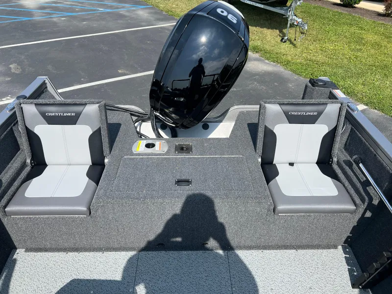 Slide: The Image of 2024 Crestliner 1650 Hawk WT boat interior with dual seats and outboard motor. - 6
