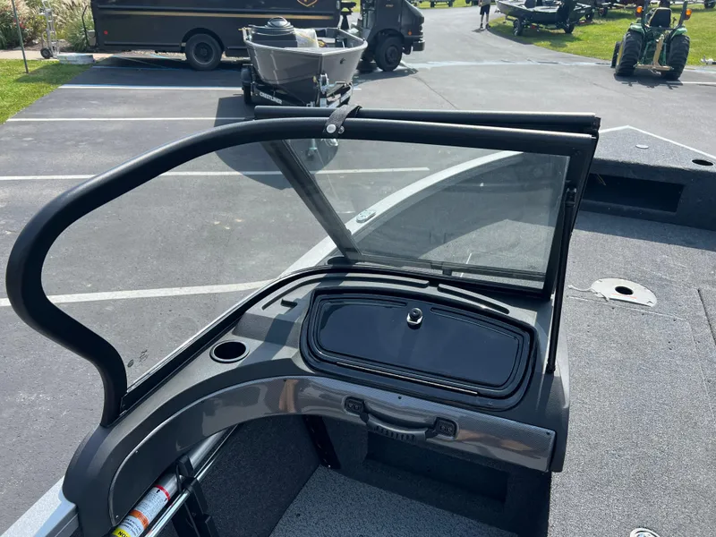 Slide: The Image of 2024 Crestliner 1650 Hawk WT boat windshield and dashboard in a parking lot. - 7