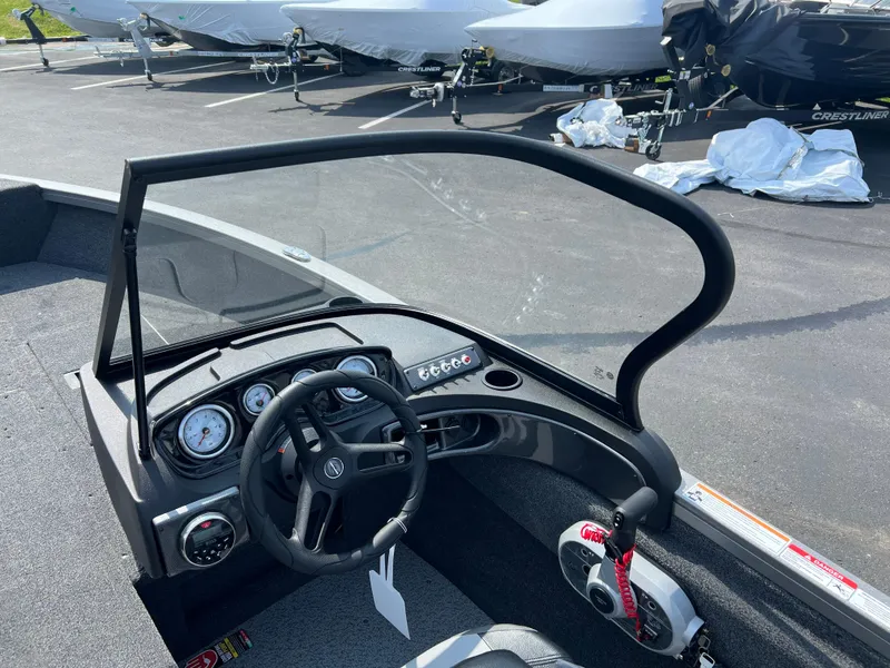 Slide: The Image of 2024 Crestliner 1650 Hawk WT boat dashboard with steering wheel and gauges. - 8