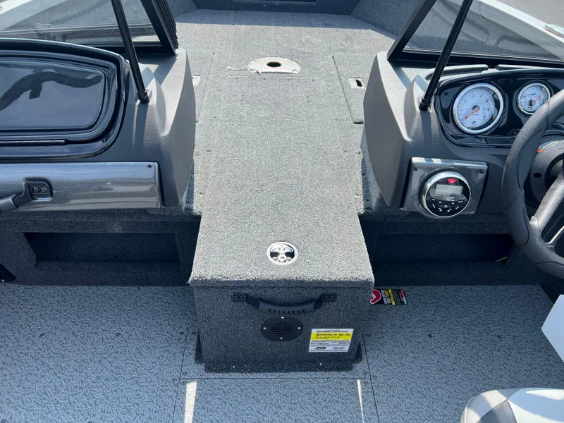 Slide: The Image of 2024 Crestliner 1650 Hawk WT boat interior with dashboard and seating area. - 9