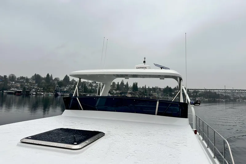Slide: The Image of 2026 Helmsman Trawlers 46 Pilothouse on a calm, overcast day. - 15