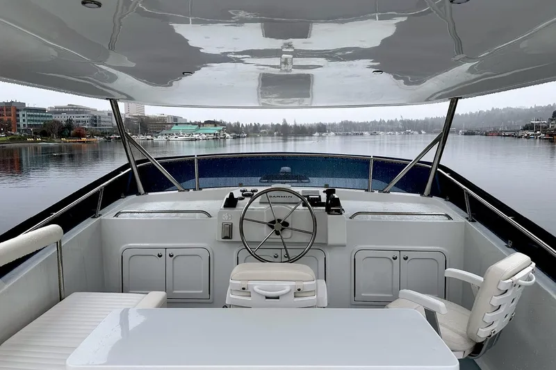 Slide: The Image of Helmsman Trawlers 46 Pilothouse 2026 yacht helm with serene waterfront view. - 19