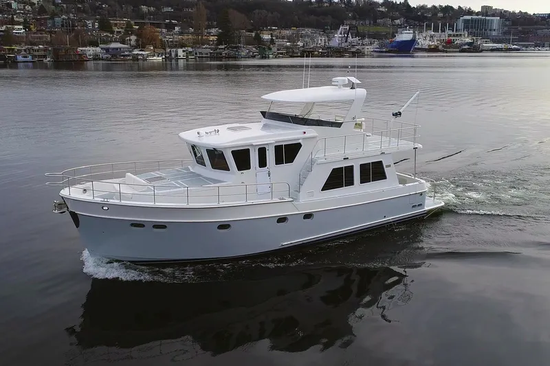 Slide: The Image of 2026 Helmsman Trawlers 46 Pilothouse cruising on calm waters. - 2
