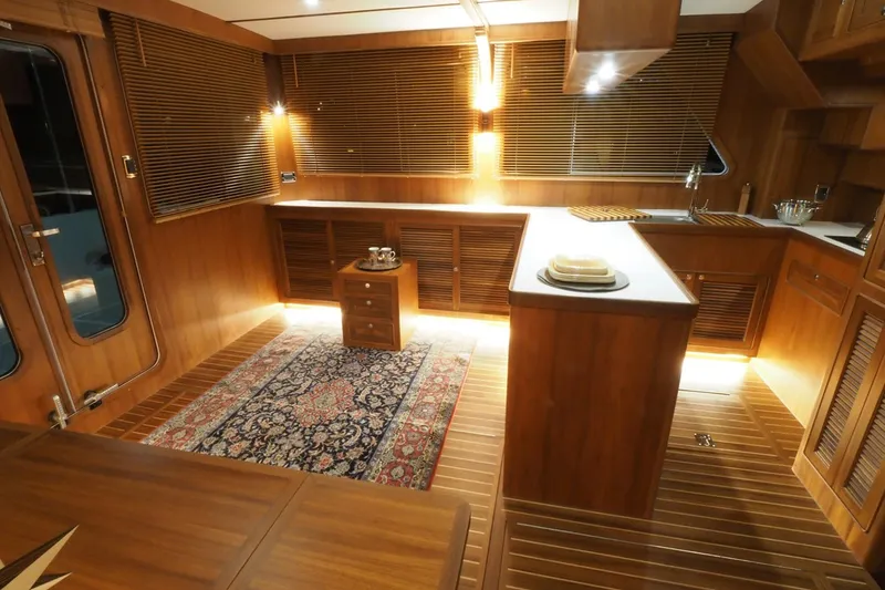 Slide: The Image of Luxurious interior of 2026 Helmsman Trawlers 46 Pilothouse with wooden finishes and elegant lighting. - 28