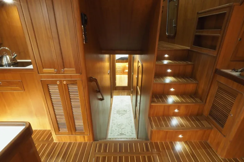 Slide: The Image of Luxurious wooden interior of 2026 Helmsman Trawlers 46 Pilothouse yacht with illuminated stairs. - 29