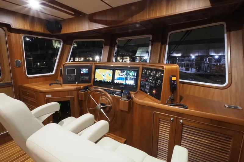 Slide: The Image of Helmsman Trawlers 46 Pilothouse 2026 interior with advanced navigation systems and luxurious seating. - 33