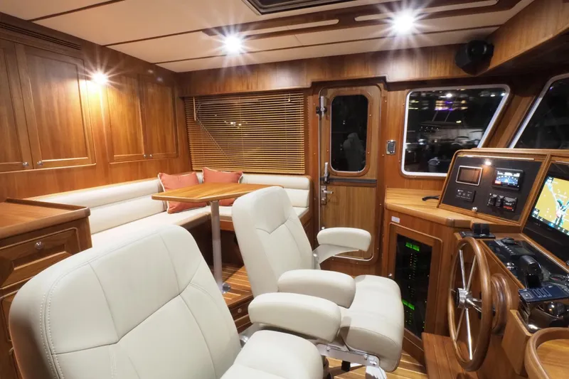 Slide: The Image of Luxurious interior of 2026 Helmsman Trawlers 46 Pilothouse with wood finish and plush seating. - 35