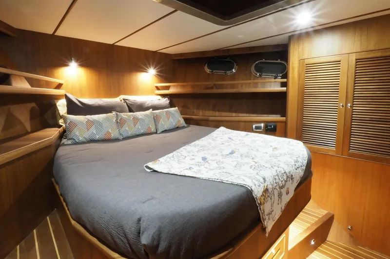 Slide: The Image of Luxurious cabin interior of 2026 Helmsman Trawlers 46 Pilothouse with cozy bed and wooden finish. - 38