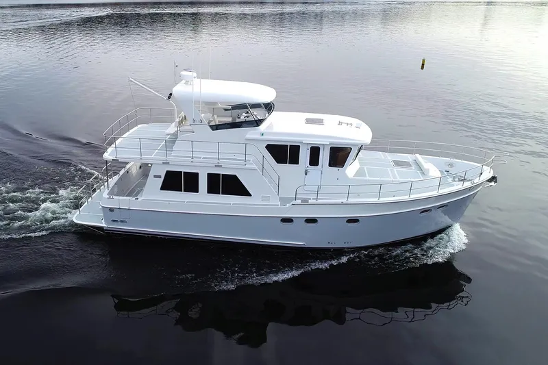 Slide: The Image of 2026 Helmsman Trawlers 46 Pilothouse cruising on calm water. - 4