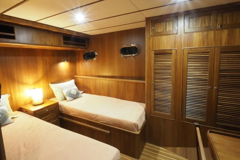 Slide: The Image of 2026 Helmsman Trawlers 46 Pilothouse cabin with twin beds and wooden interior. - 45
