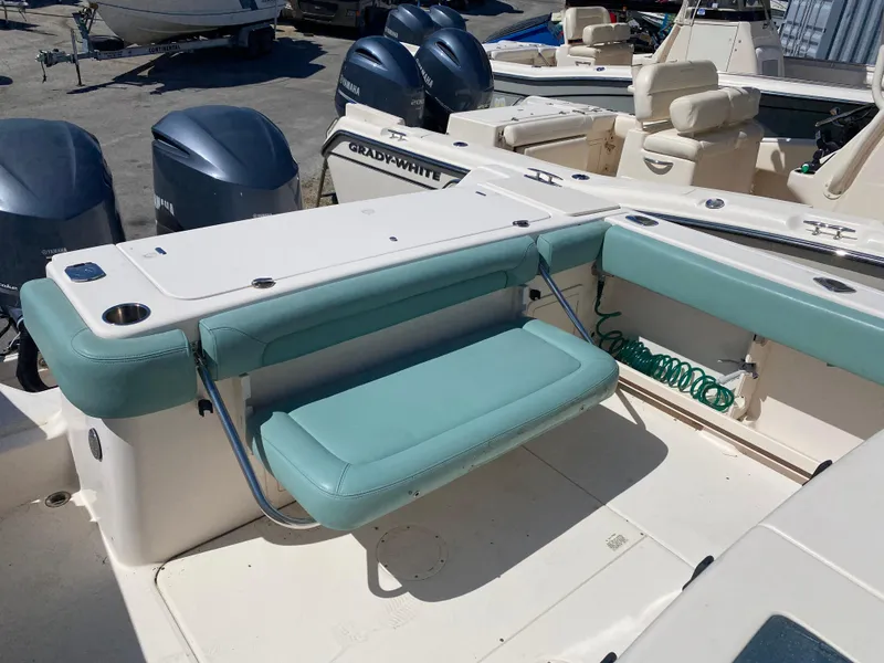Slide: The Image of 2015 Grady-White Canyon 306 boat interior with seating and dual outboard motors. - 10