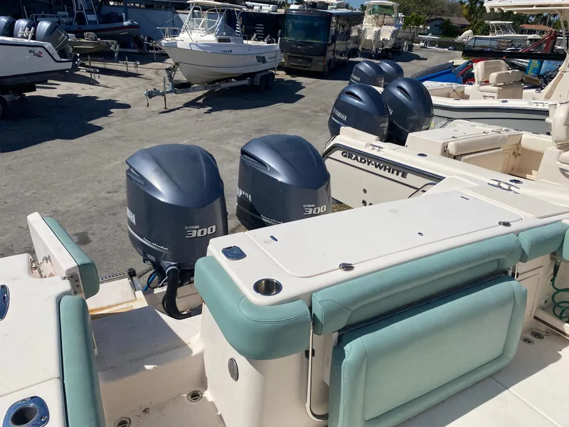 Slide: The Image of 2015 Grady-White Canyon 306 boat with twin Yamaha 300 engines in a marina. - 11