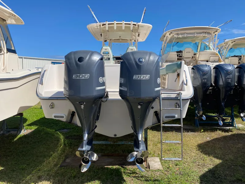 Slide: The Image of 2015 Grady-White Canyon 306 boat with twin 300 horsepower engines, displayed outdoors. - 12