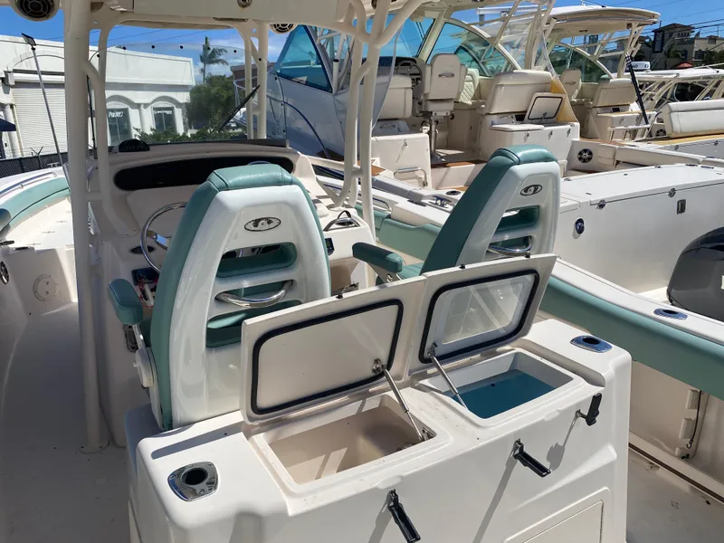 Slide: The Image of 2015 Grady-White Canyon 306 boat interior with dual seats and storage compartments. - 9