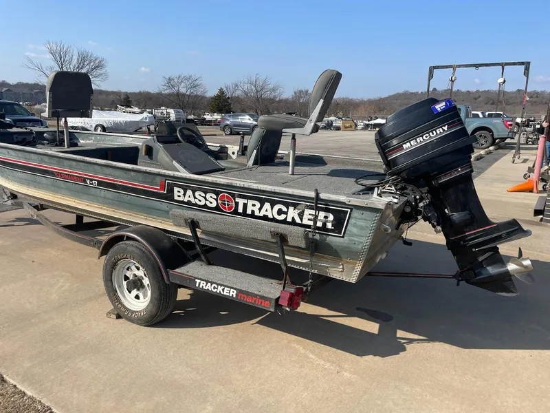Slide: The Image of 1987 Tracker Tournament TV-17 bass boat with Mercury outboard motor on trailer. - 3