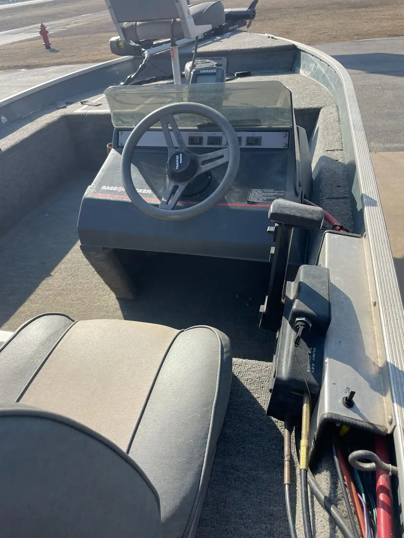 Slide: The Image of 1987 Tracker Tournament TV-17 boat interior with steering wheel and seating. - 4