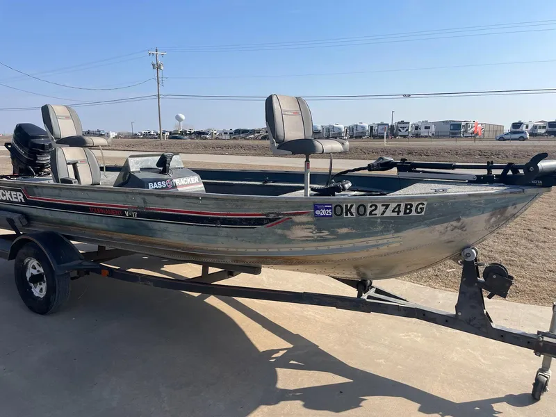 Slide: The Image of 1987 Tracker Tournament TV-17 fishing boat on trailer, parked outdoors. - 5