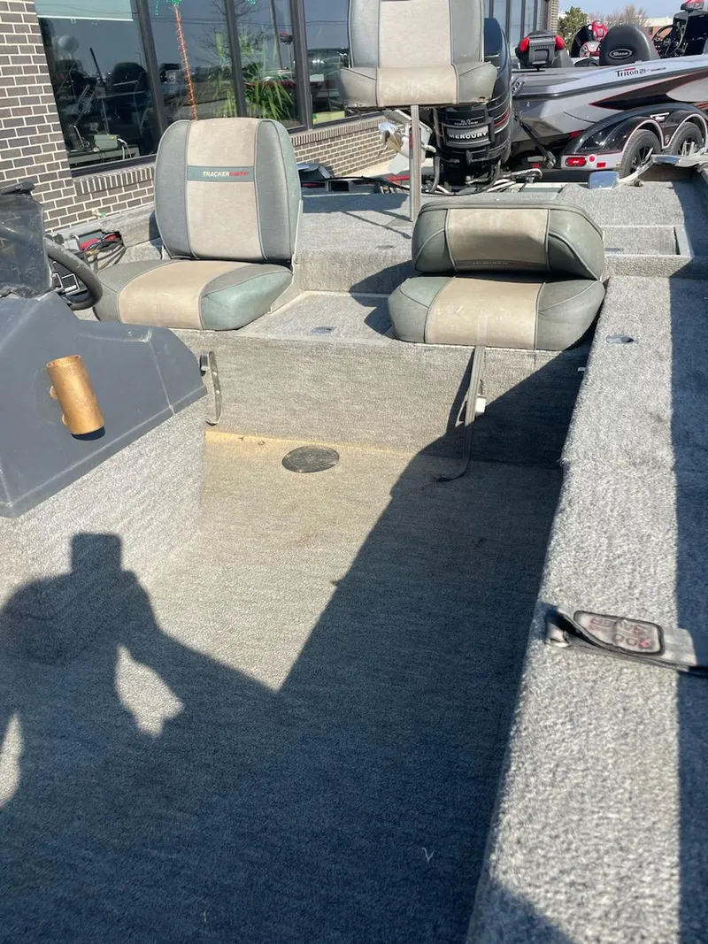 Slide: The Image of 1987 Tracker Tournament TV-17 boat interior with seating and console. - 7
