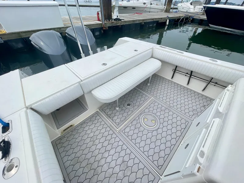Slide: The Image of 2006 Regulator 32FS boat deck with seating and storage, docked at marina. - 10