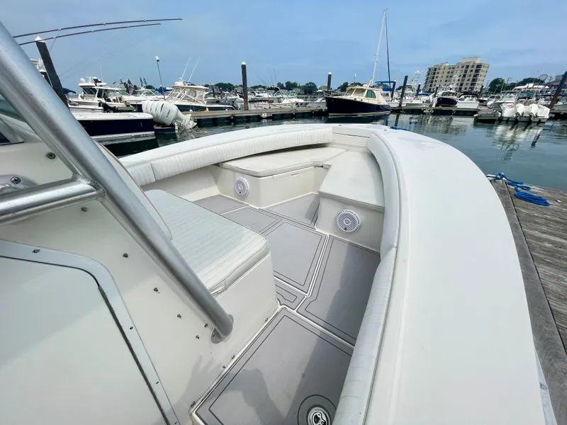 Slide: The Image of 2006 Regulator 32FS boat at marina, featuring Helm Master Joystick. - 14