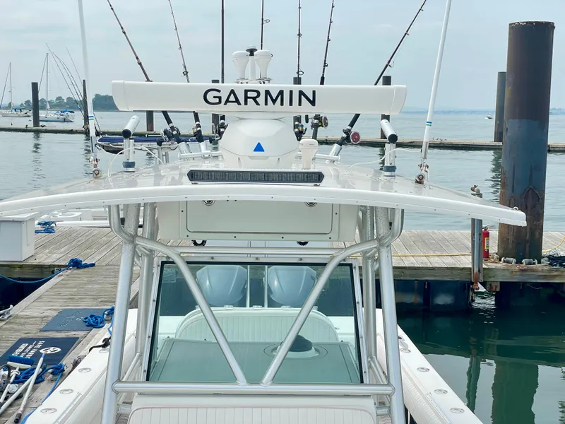 Slide: The Image of Regulator 32FS boat with Garmin equipment docked, featuring multiple fishing rods. - 17