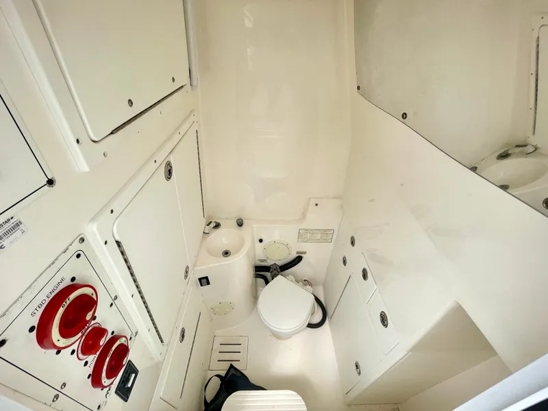 Slide: The Image of Interior of 2006 Regulator 32FS boat with helm master joystick, featuring compact bathroom. - 18