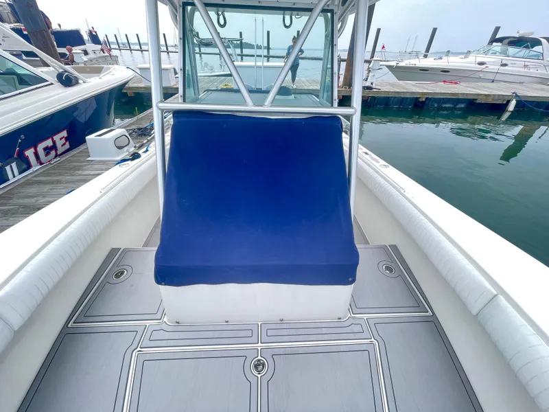 Slide: The Image of 2006 Regulator 32FS boat with blue seating and helm master joystick at dock. - 19