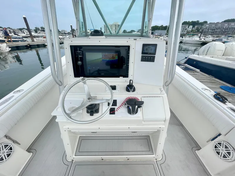 Slide: The Image of Helm of 2006 Regulator 32FS with joystick, steering wheel, and control panel at marina. - 3