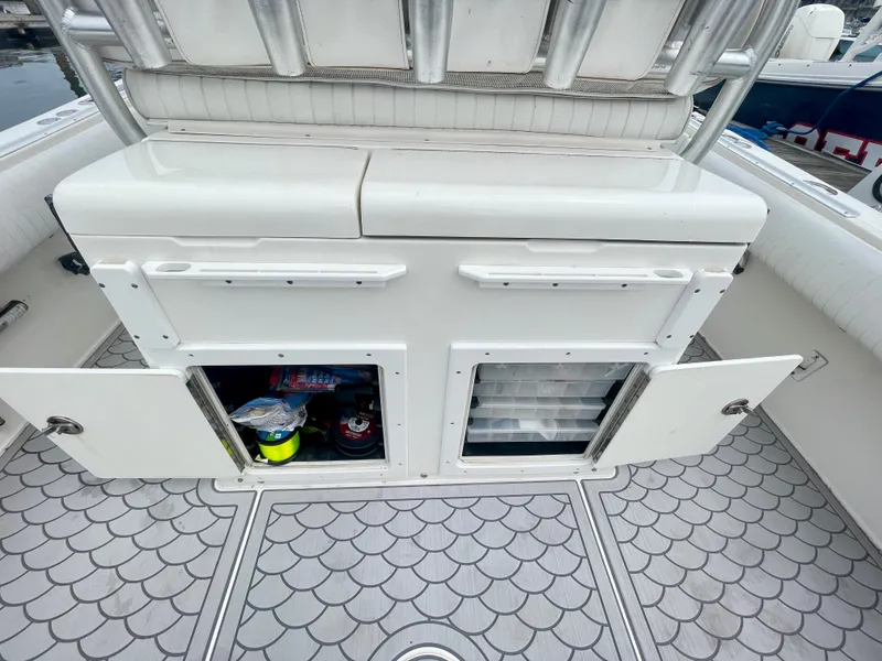 Slide: The Image of Regulator 32FS boat storage compartments with open doors, showcasing interior space and equipment. - 8